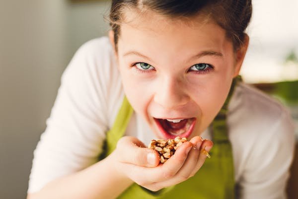 Girl Eating Nuts